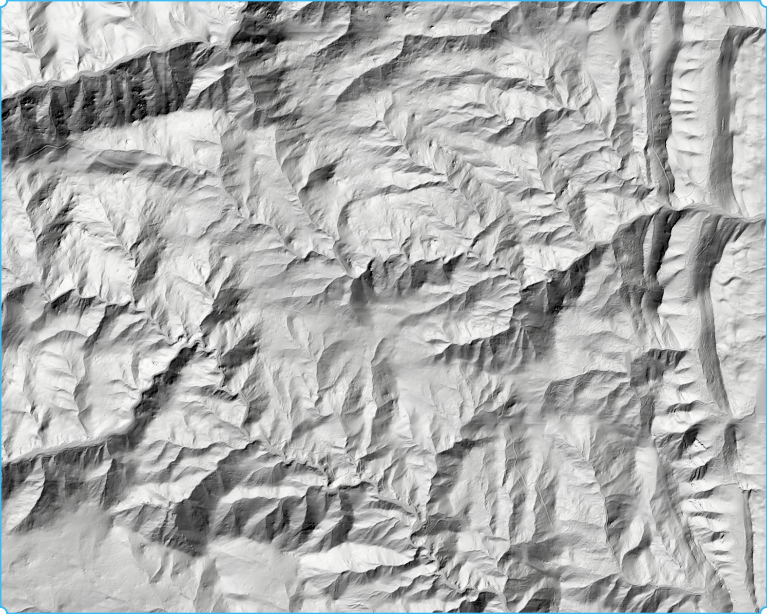 Grayscale hillshade revealing mountain ridges, valleys, and terrain relief.